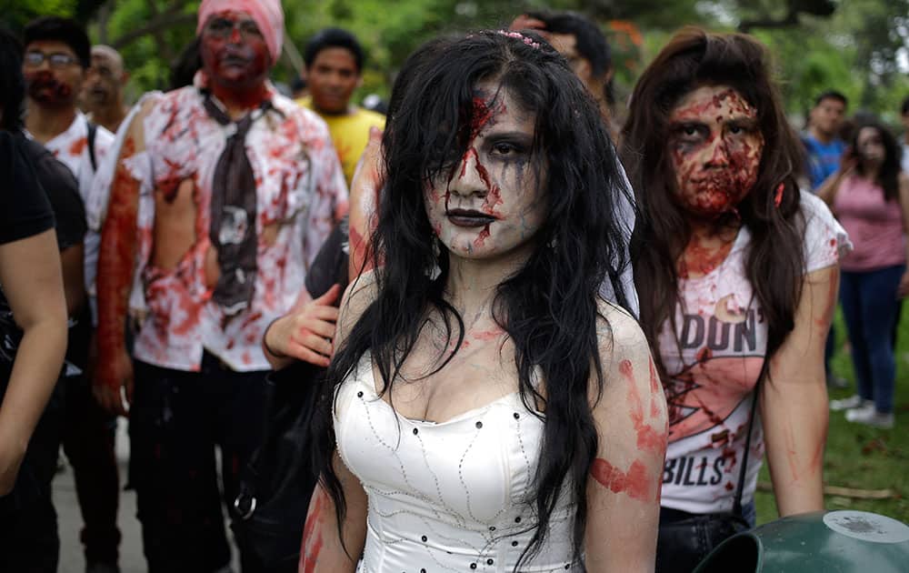 People dressed as zombies participate in the Peru Zombie Walk in Lima, Peru. Organizers asked participants to bring diapers, pajamas, toys and other items to donate to a foster home for poor children in Lima.