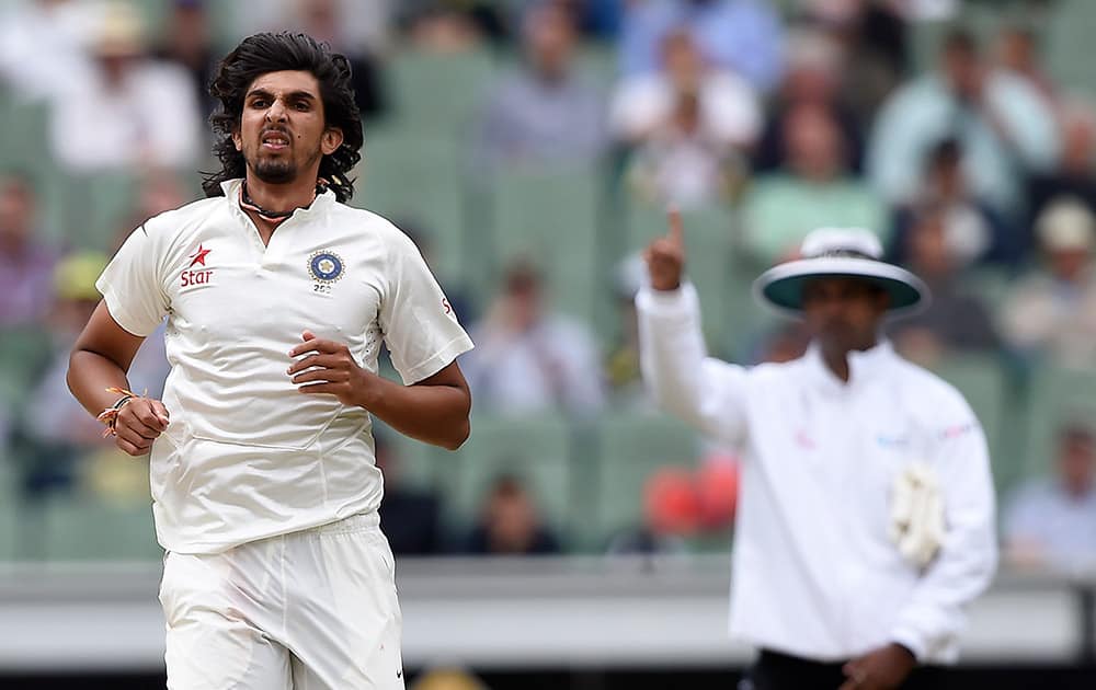 Ishant Sharma follows through on his delivery after taking the wicket of Australia's Joe Burns for 9 runs during the fourth day of their cricket test match in Melbourne, Australia.