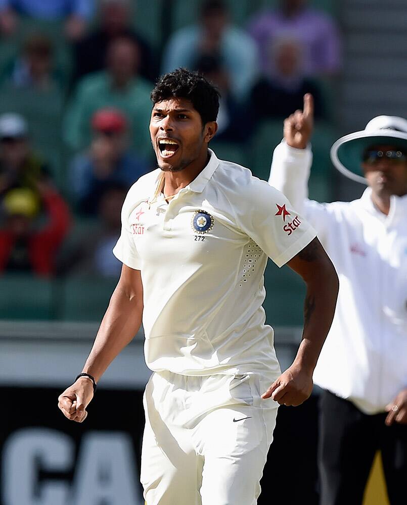 Umesh Yadav celebrates the wicket of Australia's Brad Haddin during their play on day four of their third cricket test in Melbourne, Australia.