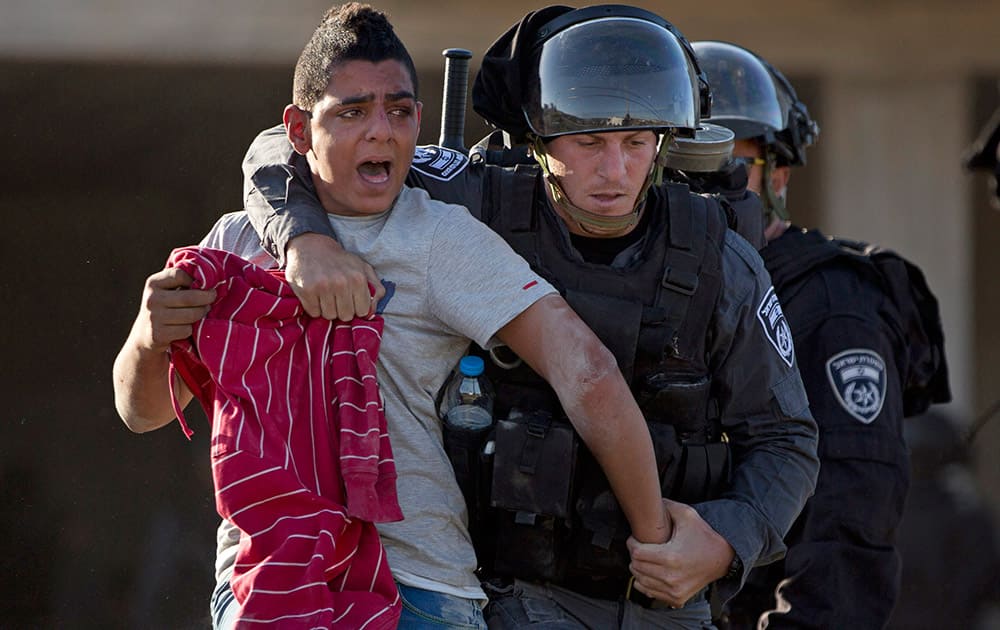 ISRAELI RIOT POLICE OFFICERS ARRESTS AN ISRAELI ARAB PROTESTER DURING A PROTEST OF THE FATAL SHOOTING OF A 22-YEAR-OLD ARAB ISRAELI WHO WAS SHOT DEAD OVER THE WEEKEND AS HE APPEARED TO BE WALKING AWAY FROM A POLICE CAR, IN THE ARAB VILLAGE OF KFAR KANA, NORTHERN ISRAEL.