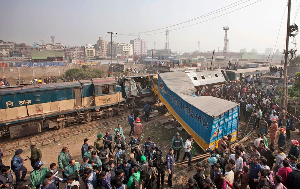 Bangladeshi people gather after a lorry rammed into a passenger train in Dhaka, Bangladesh. Several persons were killed and more than 20 others were injured in the accident, according to local reports.