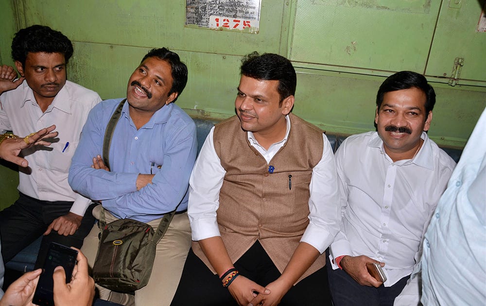 Maharashtra Chief Minister Devendra Fadnavis interacts with commuters while traveling on a suburban train from Chhatrapati Shivaji Terminus (CST) to Kalyan.