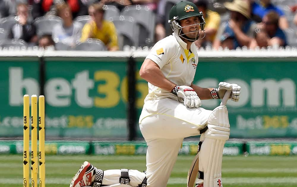 Australia's Shaun Marsh kneels on the ground after he was run out by India's Virat Kohli on 99 runs on the final day of their cricket test match in Melbourne, Australia.