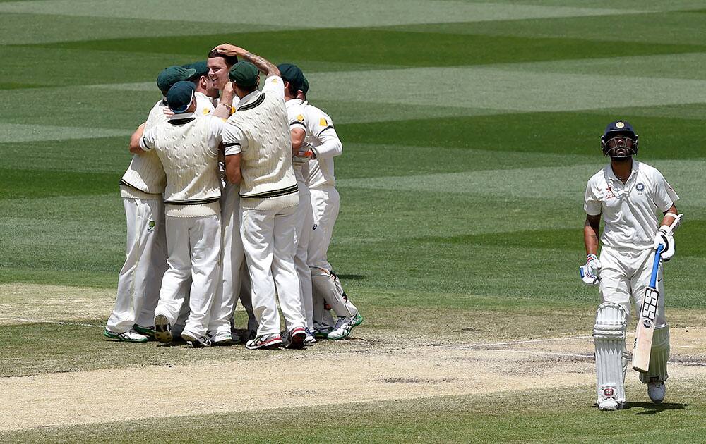 ndia's Murali Vijay walks away after he was trapped LBW for 11 runs by Australia's Josh Hazlewood on the final day of their cricket test match in Melbourne, Australia.