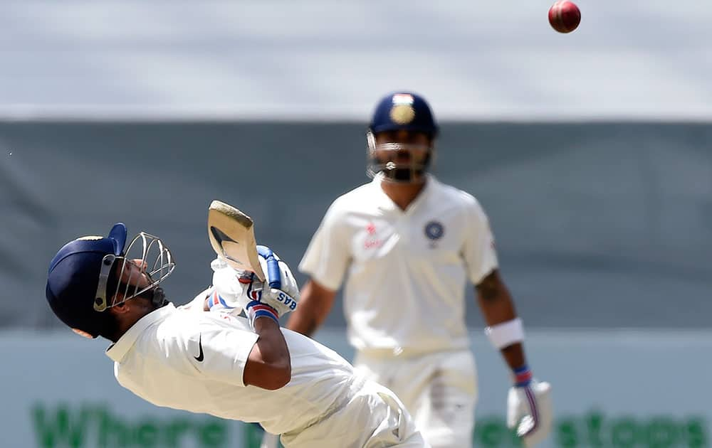 India's Ajinkya Rahane bends back to avoid a bouncer from Australia's Mitchell Johnson on the final day of their cricket test match in Melbourne, Australia.