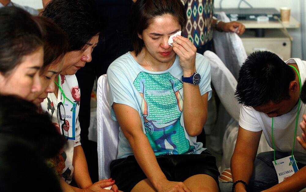 Relatives of passengers of the missing AirAsia flight QZ8501 wait distressed at the crisis center at Juanda International Airport in Surabaya, East Java, Indonesia.
