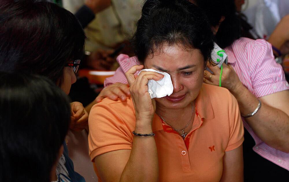 A relative of passengers of the missing AirAsia flight QZ8501 weeps as they wait at the crisis center at Juanda International Airport in Surabaya, East Java, Indonesia.