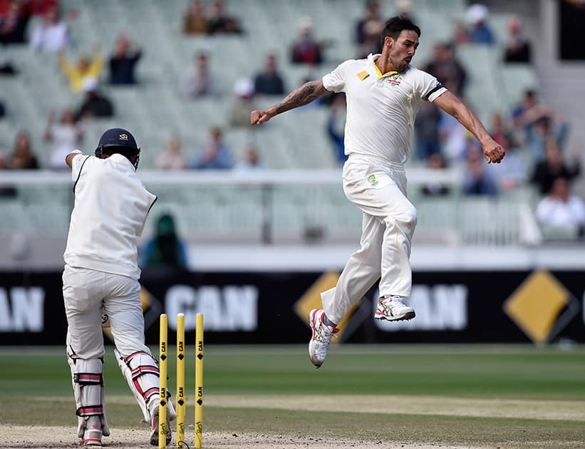 Australia's Mitchell Johnson, celebrates taking the wicket of India's Cheteshwar Pujara , for 21 runs on the final day of their cricket test match in Melbourne, Australia.