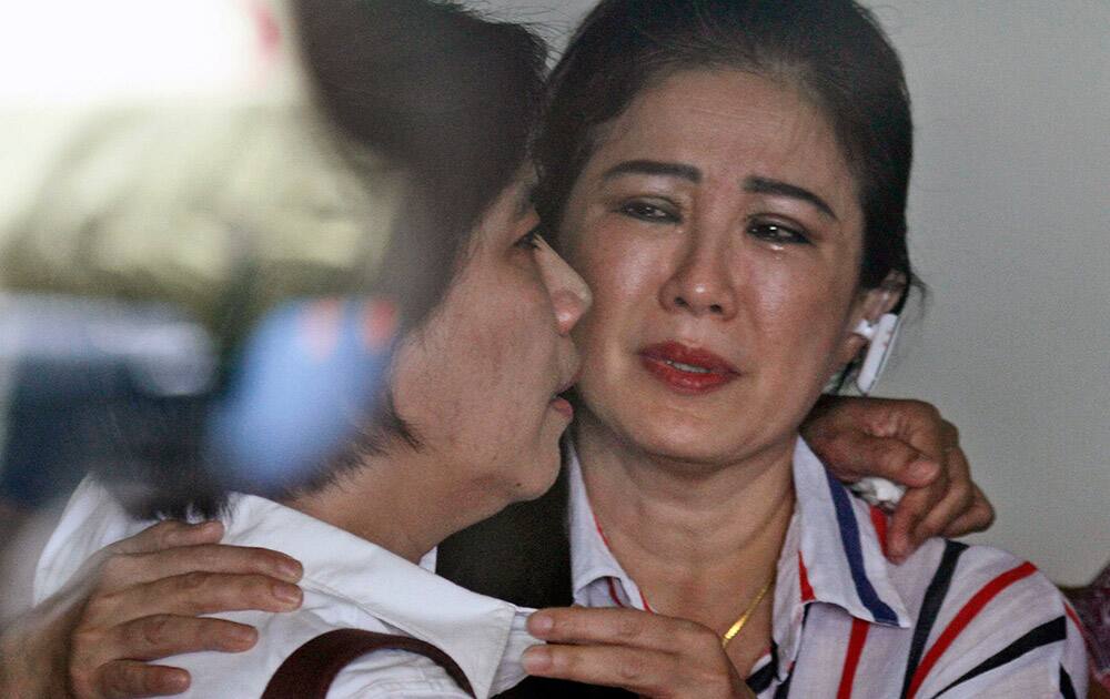 Relatives of passengers of the missing AirAsia flight QZ8501 comfort each other at the crisis center at Juanda International Airport in Surabaya, East Java, Indonesia.