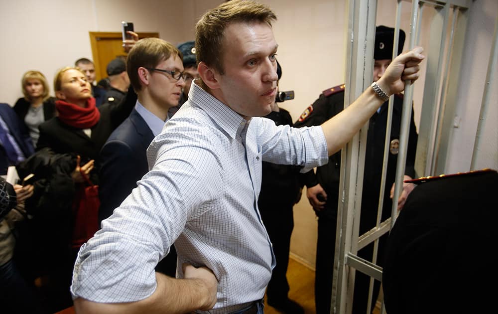 Russian opposition activist and anti-corruption crusader Alexei Navalny, 38, stands at a court in Moscow, Russia. Alexei Navalny, the anti-corruption campaigner who is a leading foe of Russian President Vladimir Putin, has been found guilty of fraud and given a suspended sentence of three and a half years. 