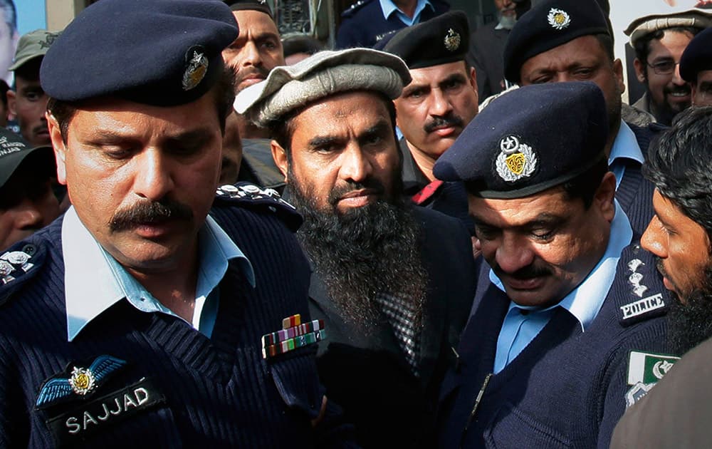 Pakistani police officers escort Zaki-ur-Rahman Lakhvi, the main suspect in the Mumbai terror attacks in 2008, after his court appearance in Islamabad, Pakistan.