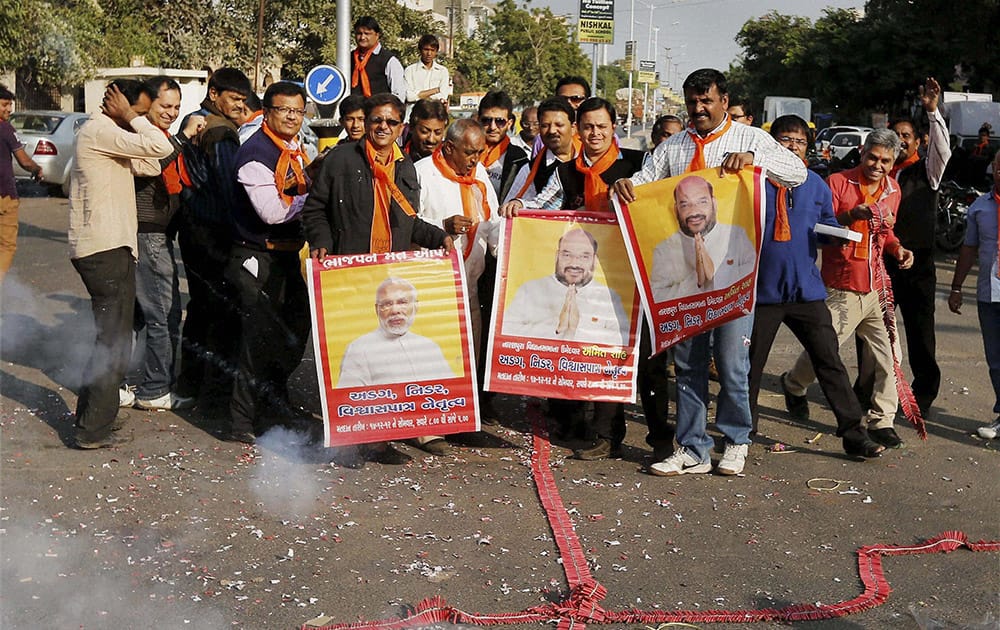 BJP supporters celebrate in Ahmedabad on Tuesday after a special CBI court in Mumbai discharged BJP president Amit Shah in the fake encounter cases of Sohrabuddin Sheikh and Tulsiram Prajapati. 