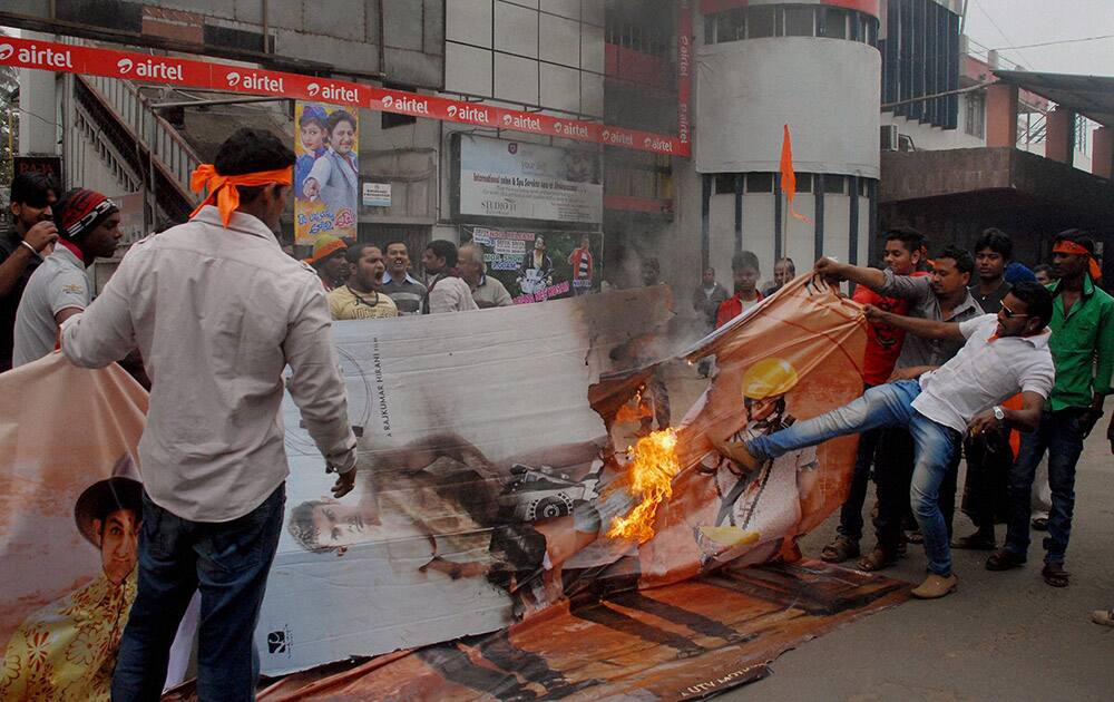 Bajrang Dal activists tear hoardings of the film PK while protesting its screening at a movie theatre in Bhubaneswar.