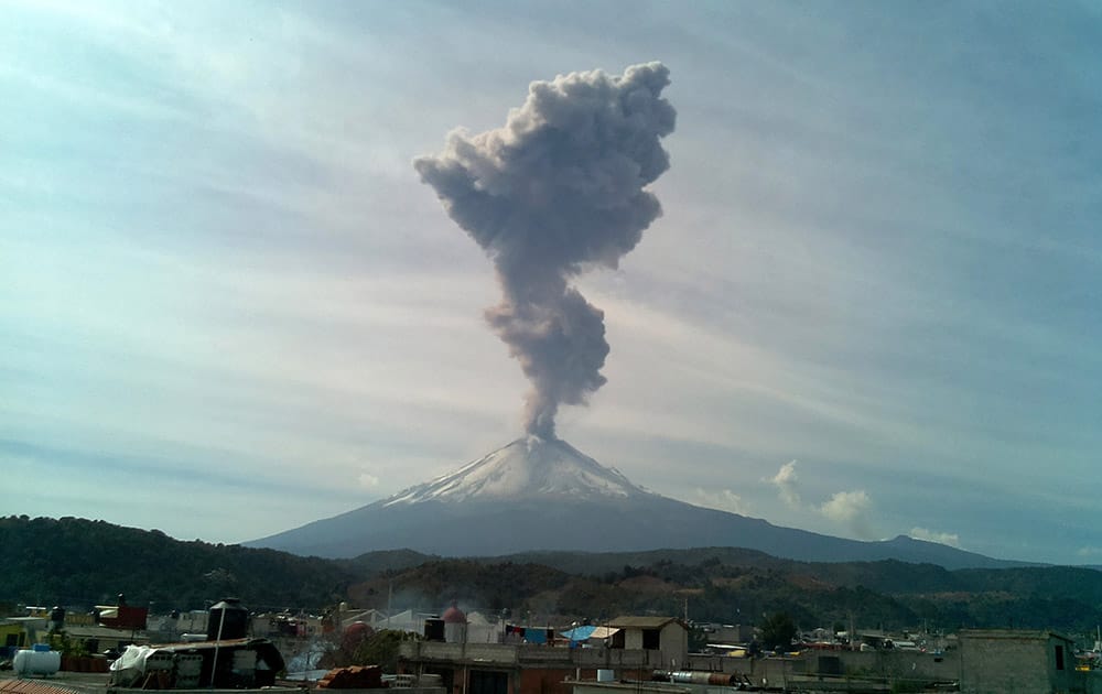 A plume of smoke, ash and steam rises from the Popocatepetl volcano, seen from the town of San Nicolas de los Ranchos, Mexico.