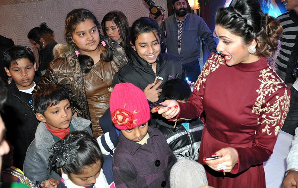 Bollywood actress Prachi Desai  speaks with children in Faridabad.