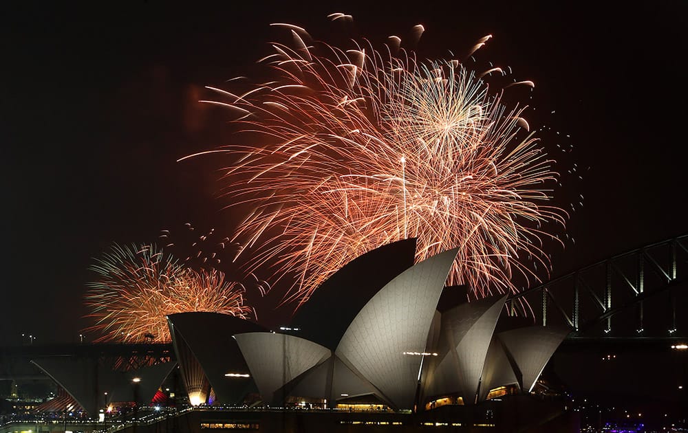 Fireworks explode over the Opera House and the Harbour Bridge during New Years Eve celebrations in Sydney, Australia.