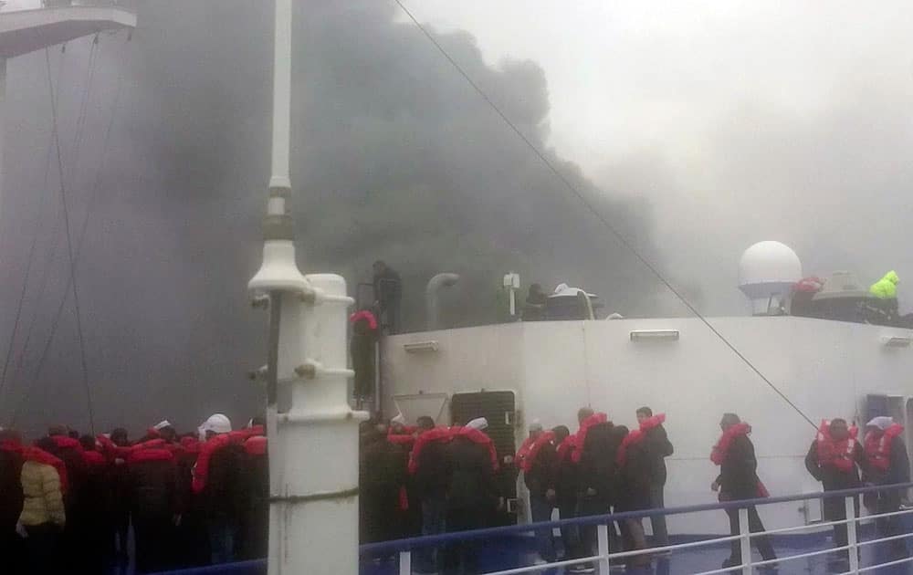 Passengers of the Italian-flagged ferry Norman Atlantic wait to be rescued after it caught fire in the Adriatic Sea. More than 400 people were rescued from the ferry, most in daring, nighttime helicopter sorties that persisted despite high winds and seas, after a fire broke out before dawn Sunday on a car deck.