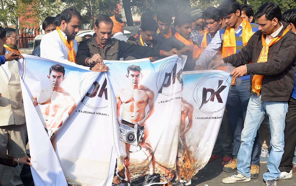 Bajrang Dal activists burn posters during a protest against screening of the film PK, in Jaipur.