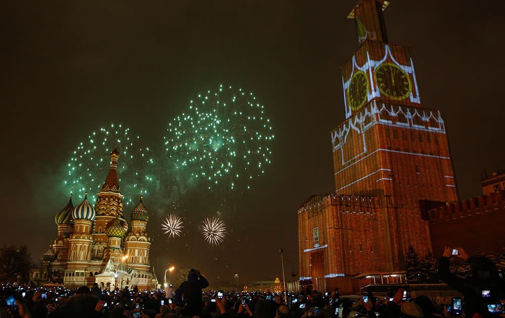 The projection of Spassky (Saviour) tower is seen over the scaffold covering the tower, which is user renovation, as fireworks explode over the Red Square during the New Year celebration, in Moscow, Russia.