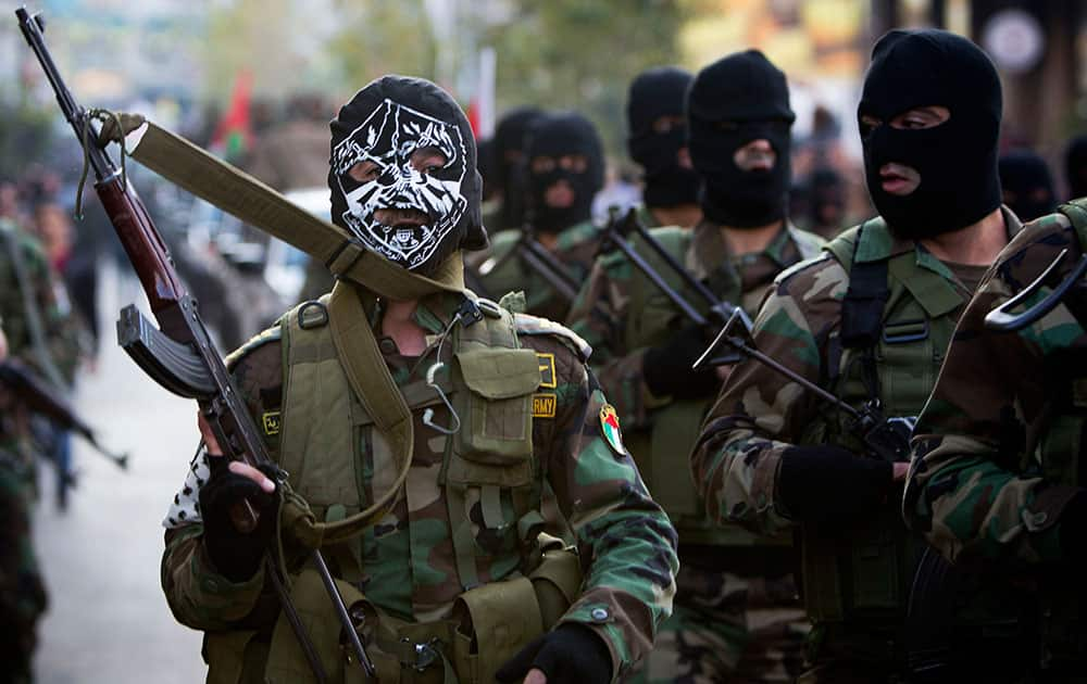 Palestinian security forces march, as they mark the 50th anniversary of the Fatah movement in the West Bank city of Ramallah.