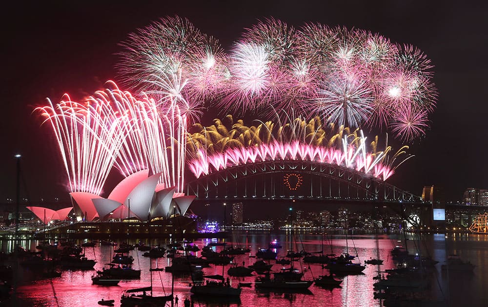 Fireworks explode over the Opera House and the Harbour Bridge during New Years Eve celebrations in Sydney.