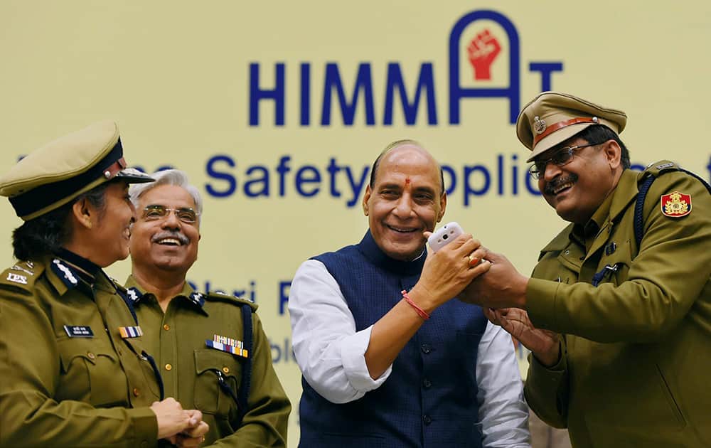 Home Minister Rajnath Singh with Delhi police Commissioner B S Bassi during the launch of mobile phone based application Himmat for the safety of women in the the capital, in New Delhi.