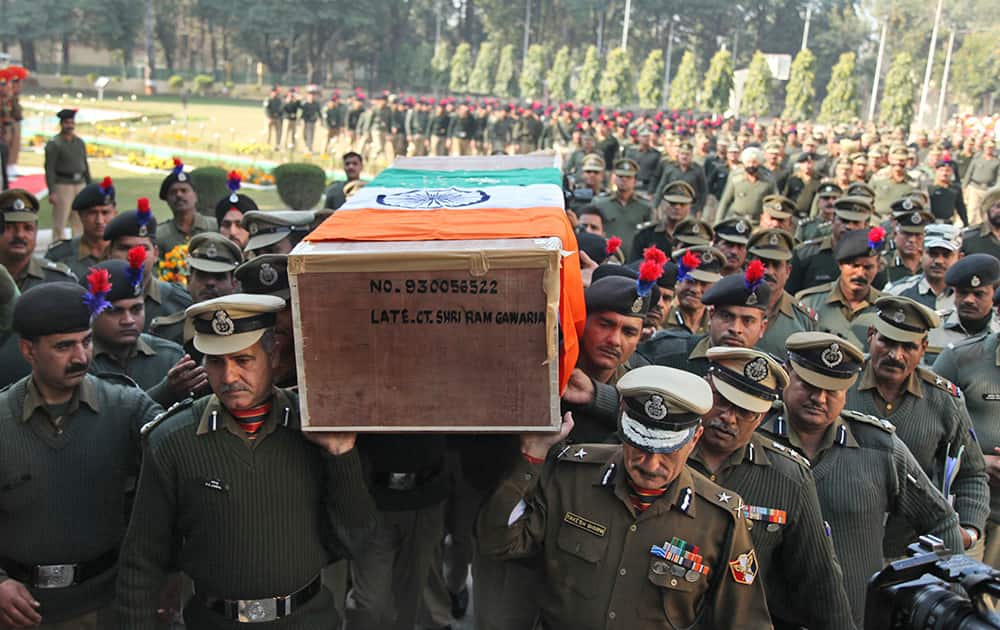 Border Security Force (BSF) officers carry the coffin of their colleague who was killed in a India Pakistan cross border firing, in Jammu.