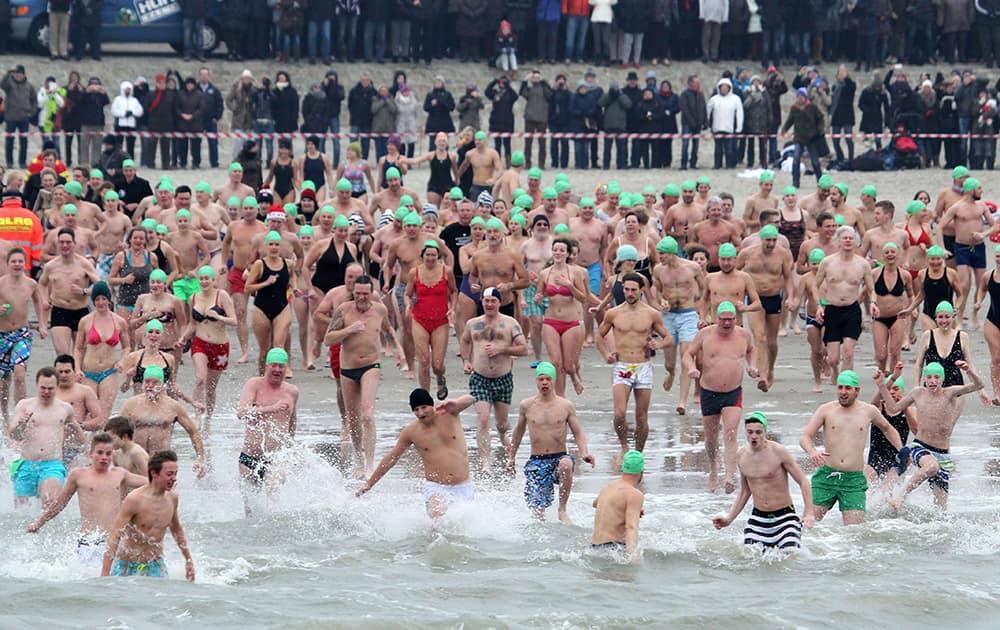 Several hundred people take part in the traditional New Year's swim on the island of Norderney in the North Sea.