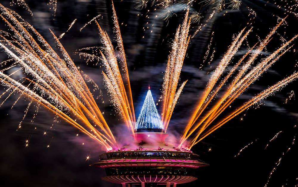 Colorful bursts of fireworks explode along the 605-foot height of the Space Needle during the 'T-Mobile New Year’s Eve at the Needle' event, in Seattle, Washington.