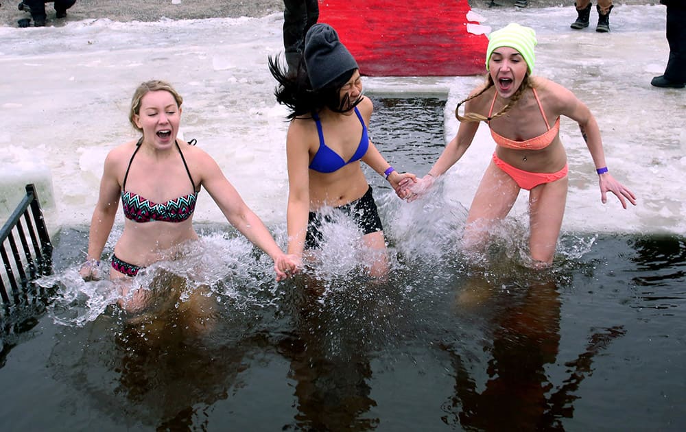 Participants take the plunge into icy water at the 2015 New Year polar bear dip at Britannia Beach in Ottawa, Canada.