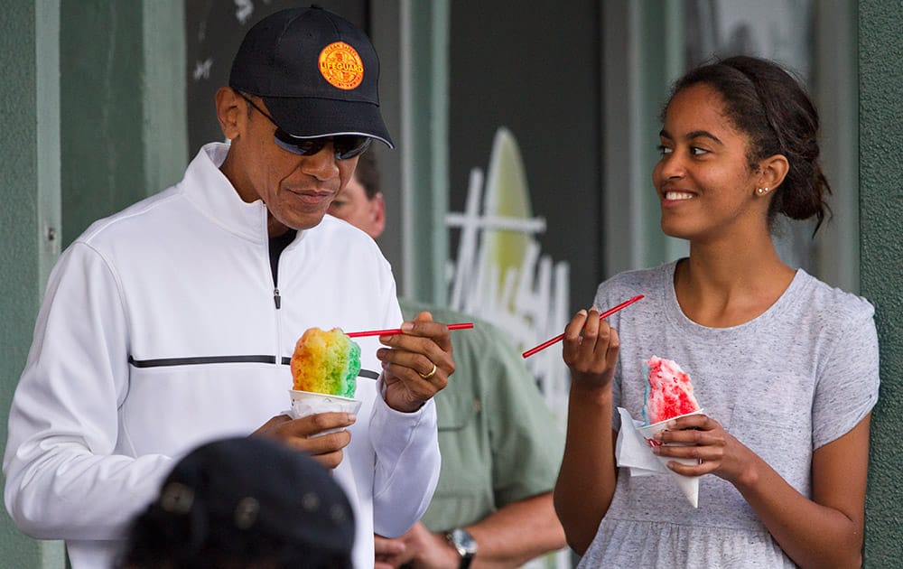 President Barack Obama eats shave ice with daughter Malia Obama at Island Snow, in Kailua, in Hawaii during the Obama family vacation.