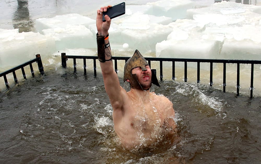A man take a selfie as he takes part in the 2015 New Year polar bear dip at Britannia Beach in Ottawa, Canada.