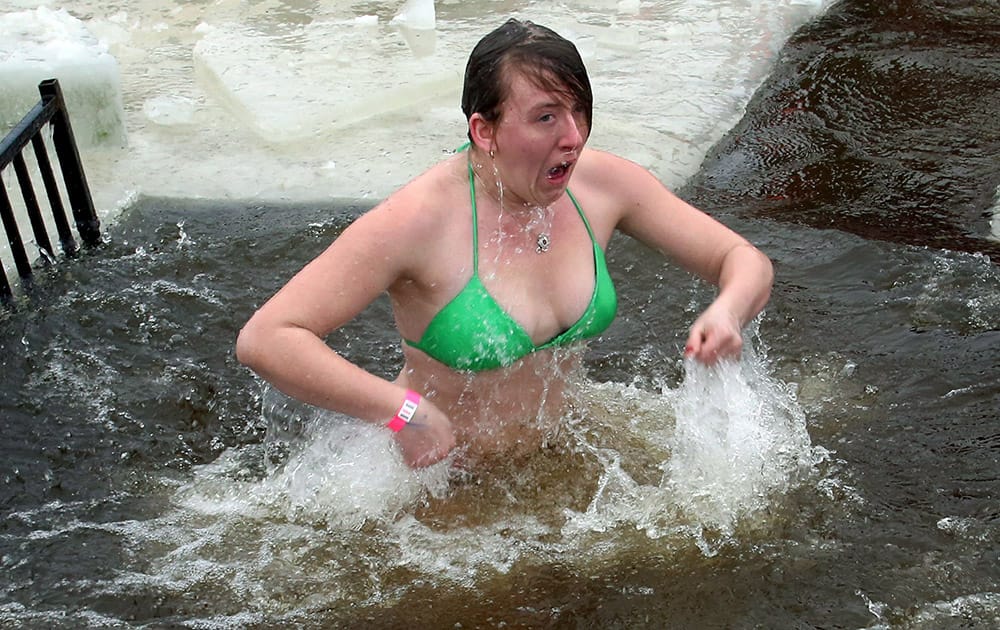 A woman takes part in the 2015 New Year polar bear dip at Britannia Beach in Ottawa, Canada.