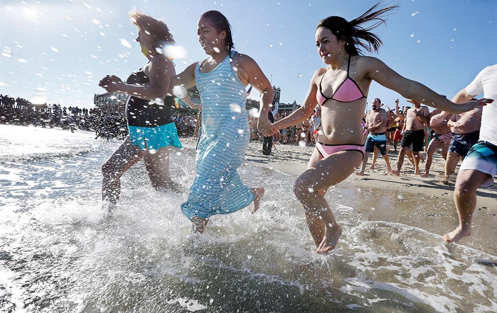 People run in the cold Atlantic Ocean during the Sons of Ireland's annual New Year's Day Polar Bear Plunge on a sunny, but frigid, in Asbury Park.
