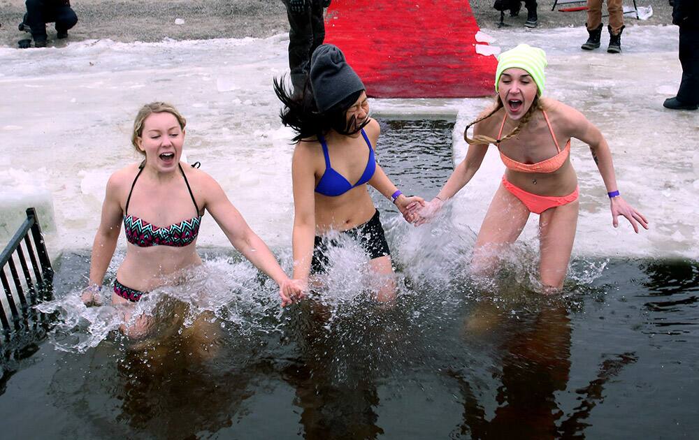Participants take the plunge into icy water at the 2015 New Year polar bear dip at Britannia Beach in Ottawa, Canada.