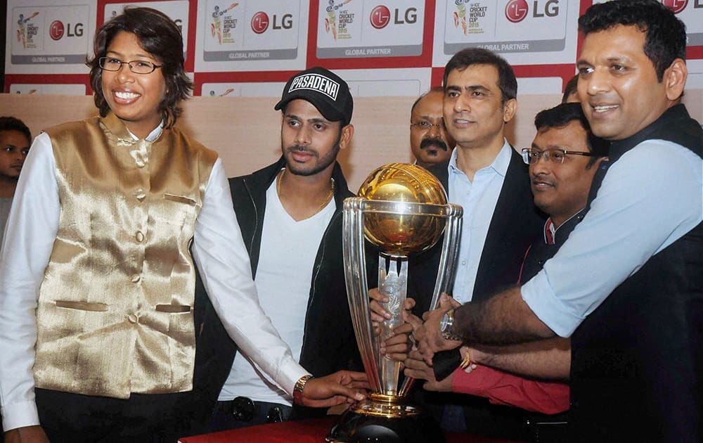 Cricketers Jhulan Goswami, Manoj Tiwari, chess grandmaster Dibyendu Barua and others pose with the ICC World Cup 2015 Trophy at a promotional event in Kolkata.