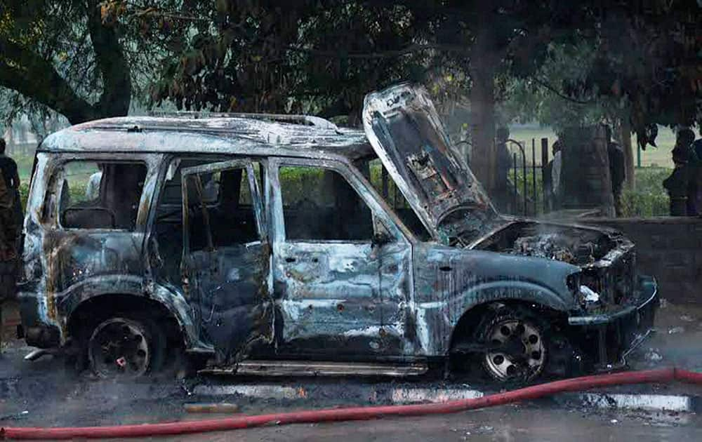 A charred vehicle after a clash between BJP and AAP workers in New Delhi.