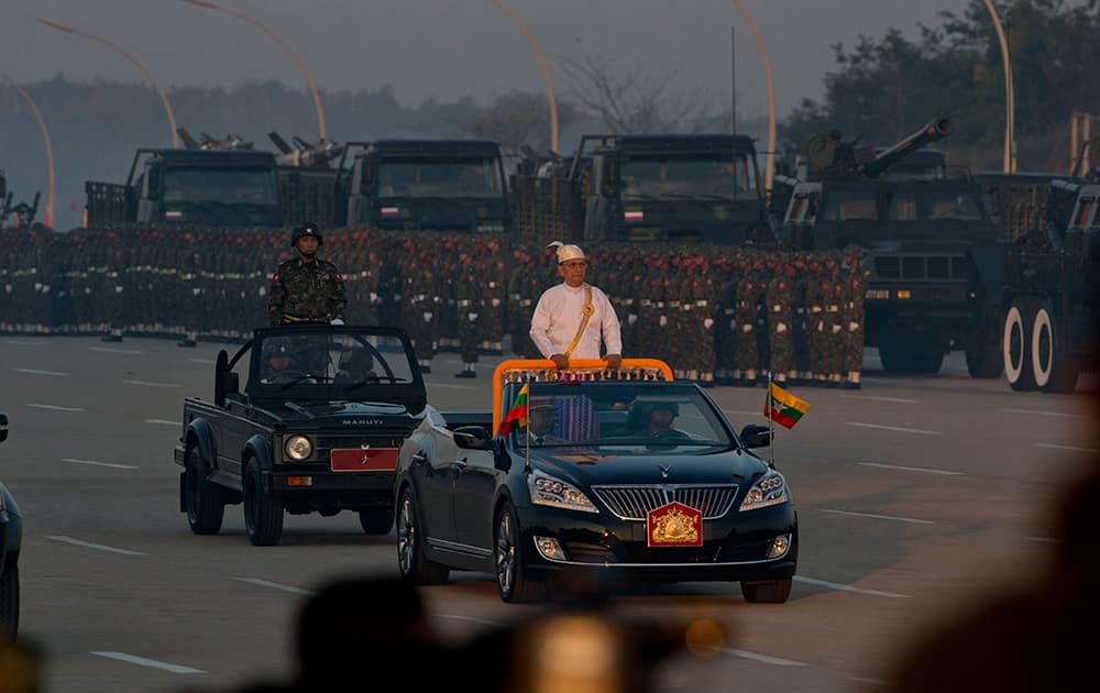 Myanmar President Thein Sein, center, rides in an open vehicle inspecting officers and military hardwear during a ceremony to mark Myanmar's 67th anniversary of Independence Day in Naypyitaw, Myanmar.