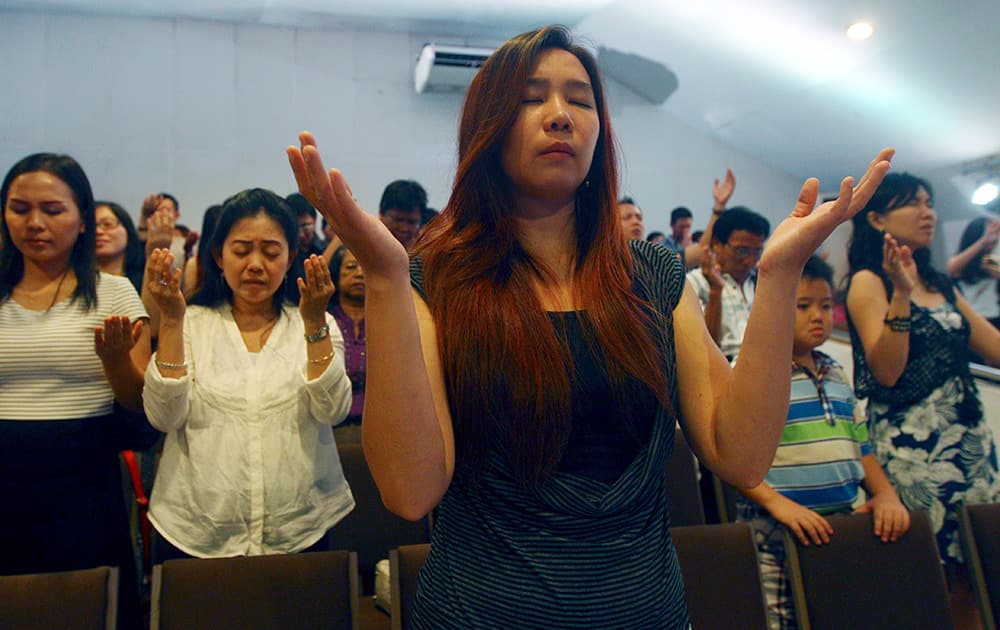 Members of Mawar Sharon church attend a prayer service in Surabaya, East Java, Indonesia. About 40 members of Mantofa's church died in the crash of AirAsia Flight 8501 which took place on Dec. 28, 2014.