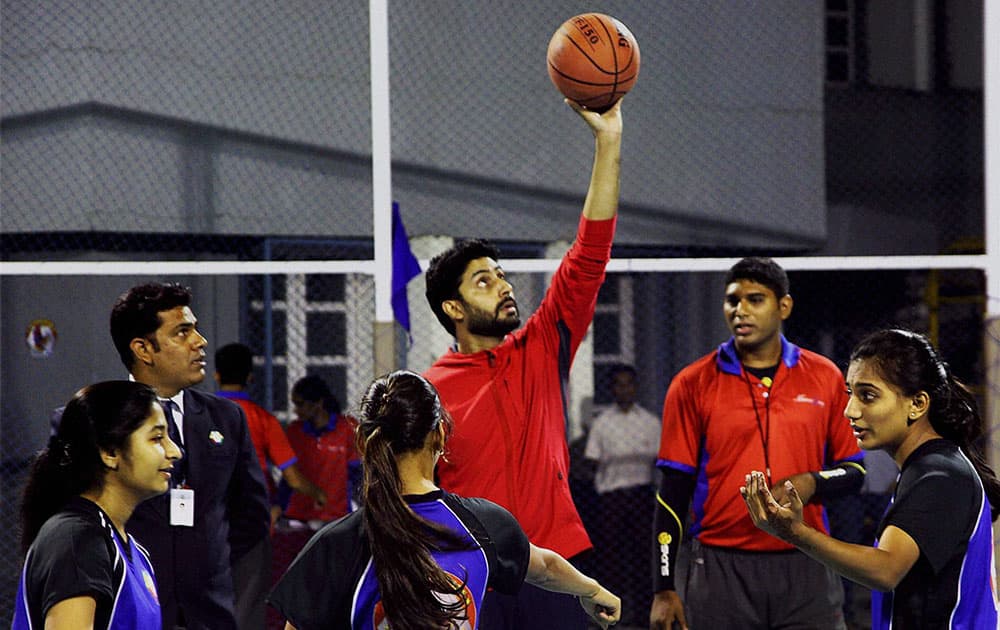 Bollywood actor Abhishek Bachchan plays basketball during the launch of a multi-sport court at Jamnabai Narsee School in Mumbai.