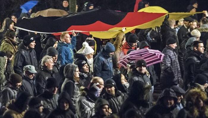 German anti-migrant march draws highest turnout, opponents rally