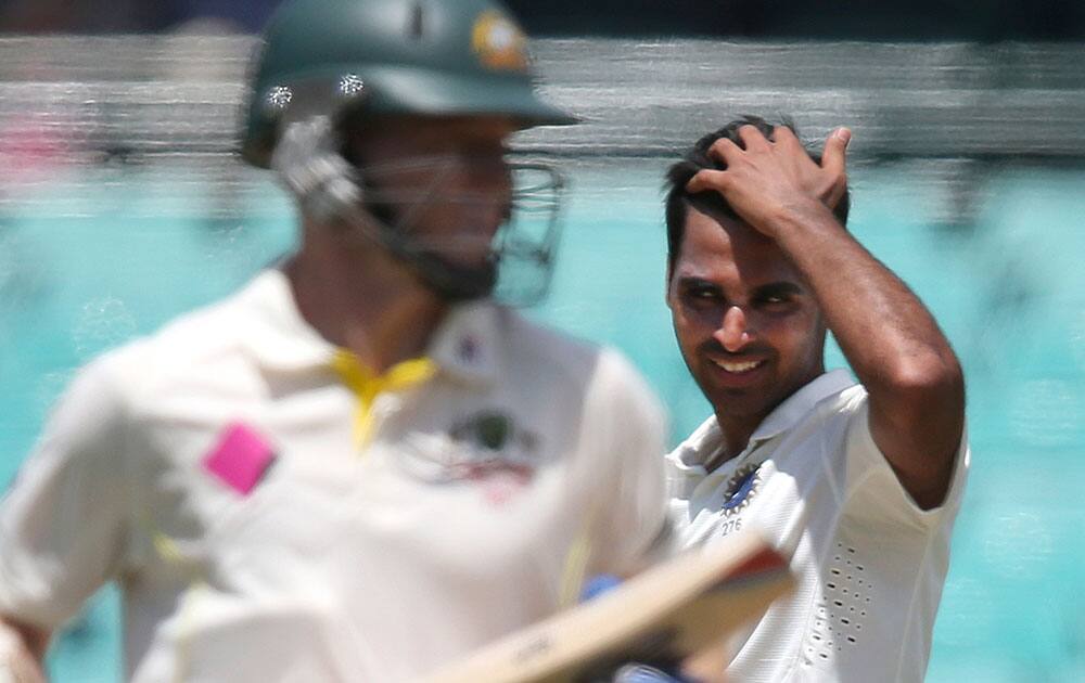 India's Bhuvneshwar Kumar runs his hand through his hair after Australia made runs off his bowling during their cricket test match in Sydney.
