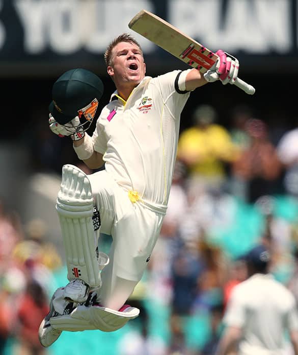 Australia's David Warner jumps to celebrate making 100 runs against India during their cricket test match in Sydney.