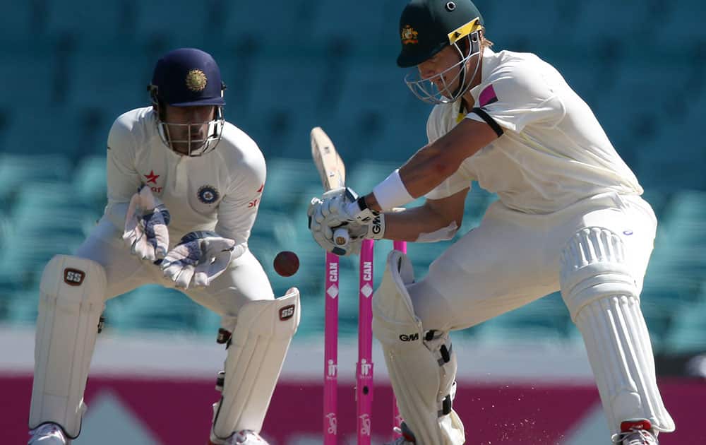 Australia's Shane Watson drives the ball in front of India's Wriddhiman Saha during their cricket test match in Sydney.