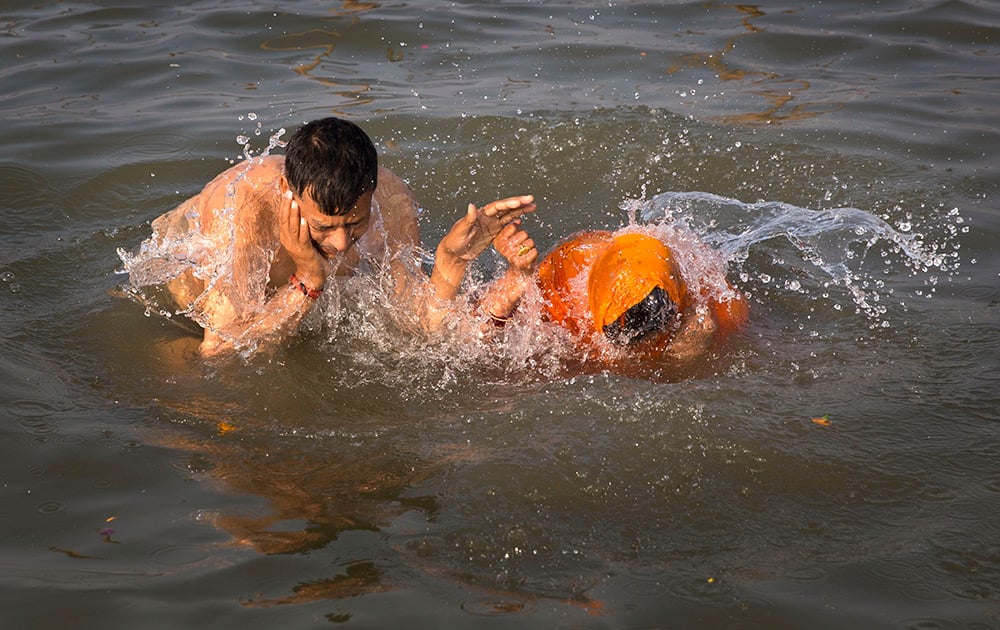 Hindu devotees take holy dips at 