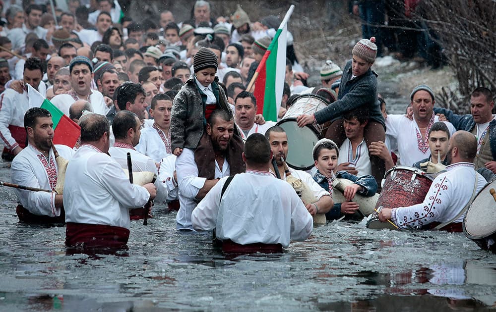 Believers sing and dance in the icy water of the river Tundzha as they celebrate Epiphany day, a Christian festival, in the town of Kalofer, Bulgaria.