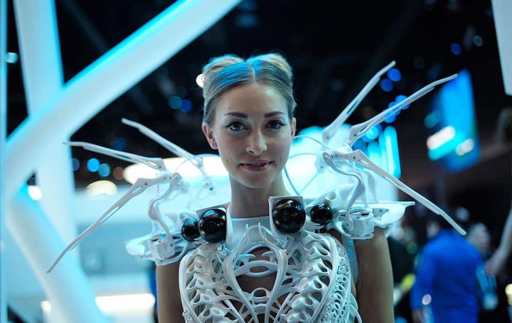 A model wearing robotic dress with proximity sensors pauses for photos at the Intel booth at the International CES, in Las Vegas.