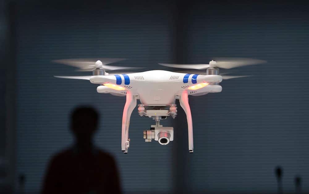A staff member from DJI Technology Co. demonstrates the remote flying with his Phantom 2 Vision+ drone inside his office in Shenzhen, south China's Guangdong province. Founded in 2009 by an engineer with a childhood love of radio-controlled model planes, DJI has become the leading supplier in the fast-growing market for civilian drones - possibly the first Chinese brand to achieve No. 1 status in a global consumer product.