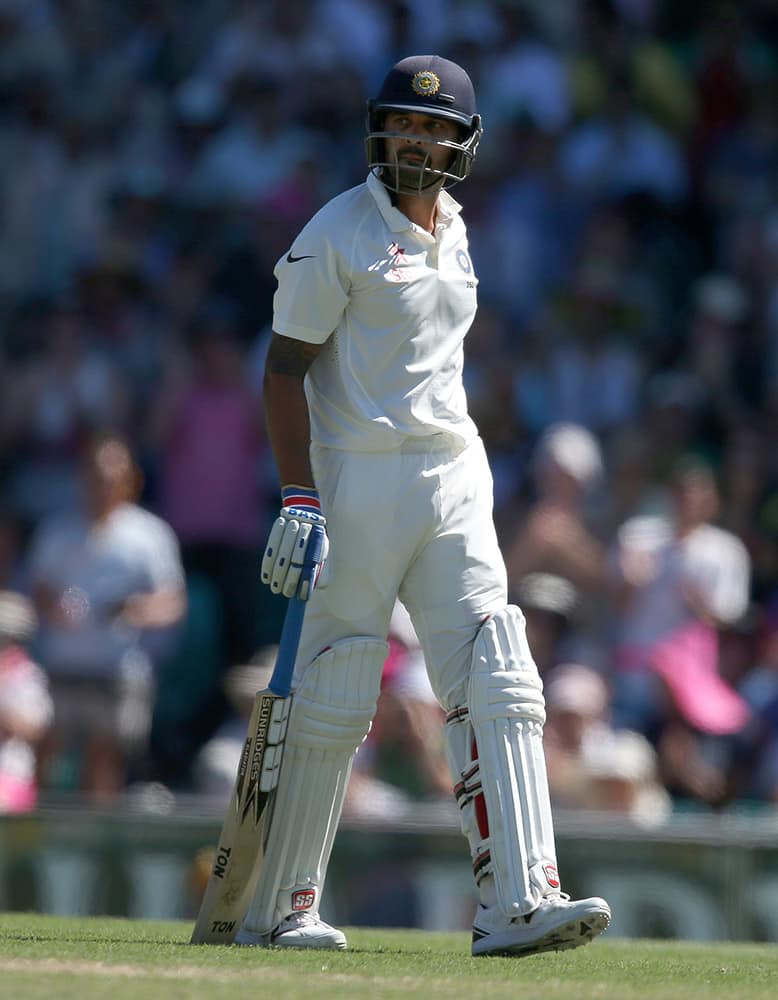 India's Murali Vijay walks off after he is caught out for no score against Australia on the second day of their cricket test match in Sydney, Australia.