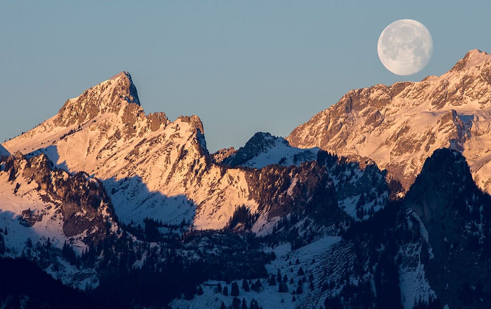 The waning moon is setting over the mountain 'Les Cornettes de Bise' located at the border of the Haute-Savoie and the Valais canton of Switzerland in the Chablais Alps, photographed from Glutieres, Switzerland.